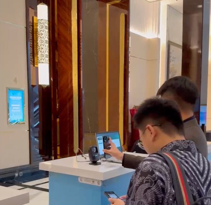 Attendee scanning a QR e-ticket at a self check-in kiosk