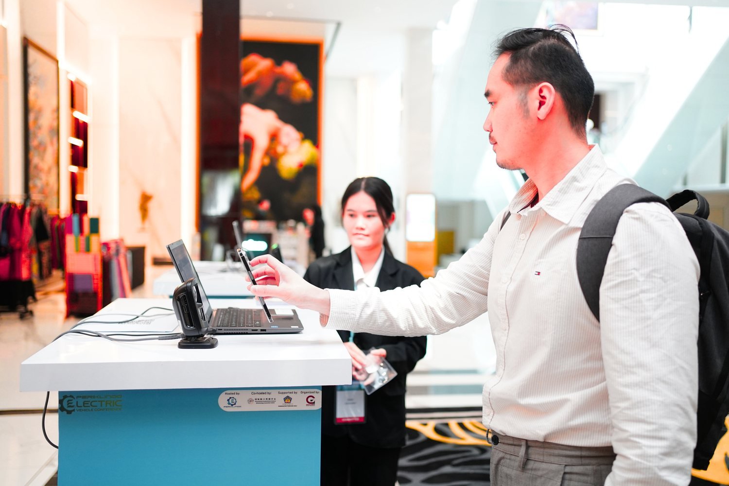 An attendee checking in at a registration kiosk